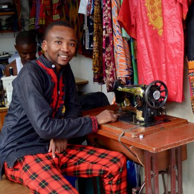 Student with sewing machine setting at table